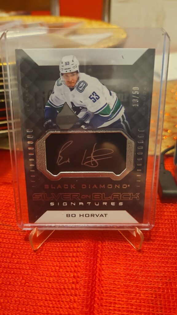 2021-22 Upper Deck Black Diamond Silver on Black Signatures Bo Horvat #SB-BH autograph card, featuring a bold silver ink signature on premium black foil, and Vancouver Canucks captain from the high-end Black Diamond set.