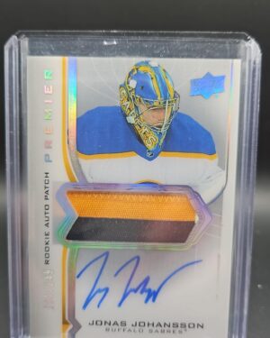 2020-21 Upper Deck Premier Jonas Johansson Patch Auto RC /249 #AR-JJ featuring a bold on-card autograph and a premium multi-color Buffalo Sabres patch, serial numbered out of 249 from Upper Deck’s high-end Premier set.
