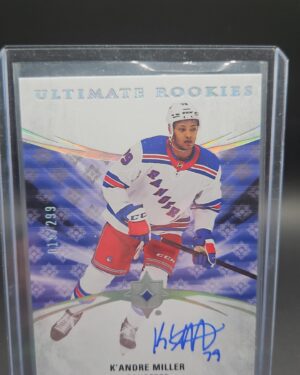 2020-21 Upper Deck Ultimate Collection K’Andre Miller Rookie Auto /299 #127, showing a bold on-card autograph, serial numbered out of 299, from the Ultimate Collection set, featuring the New York Rangers rookie in full uniform.