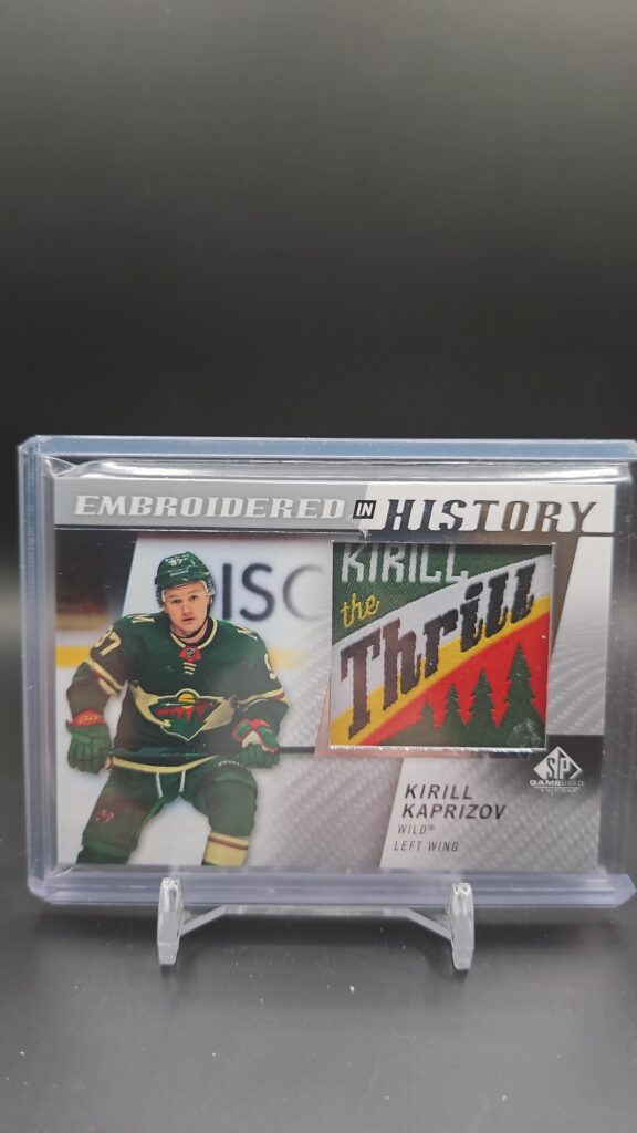 2021-22 Upper Deck SP Game Used Embroidered in History card #12 featuring Kirill Kaprizov of the Minnesota Wild, a unique embroidered memorabilia card highly sought after by NHL and Wild collectors.