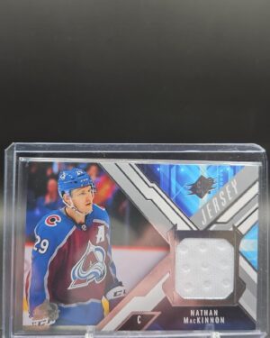 2021-22 Upper Deck SPx Jersey Nathan MacKinnon card #J-NM, Mint condition, Colorado Avalanche, game-used memorabilia, top collectible for NHL fans.