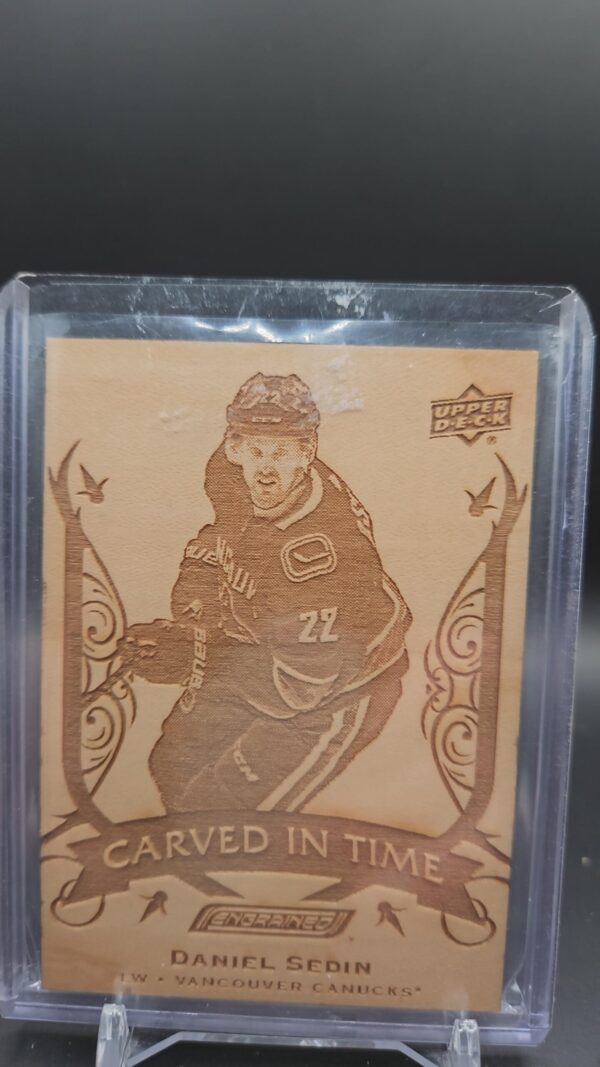 2019-20 Upper Deck Engrained Carved in Time card #CT-2 featuring Daniel Sedin of the Vancouver Canucks, a unique wood-textured collectible highly sought after by NHL and Canucks memorabilia collectors.