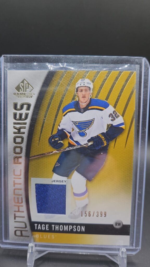 2017 SP Game Used Authentic Rookies Gold Jersey /399 Tage Thompson #97 rookie card featuring game-worn memorabilia and gold parallel, perfect for NHL collectors.