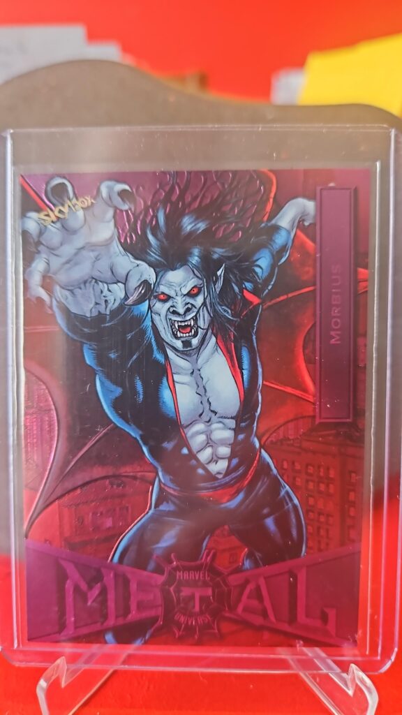 2021 Marvel Metal Universe Spider-Man Morbius Light FX Pink /75 #56 PMG card, featuring vibrant pink foil, serial numbered out of 75, and the iconic Marvel character Morbius from the sought-after Metal Universe set.