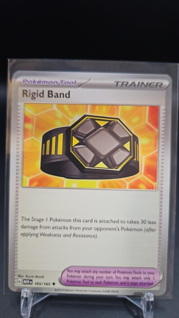 Standard non-holo Rigid Band card from the Pokémon Scarlet and Violet 151 trading card game expansion set showing a silver border, Tool icon, and damage reduction card effect.