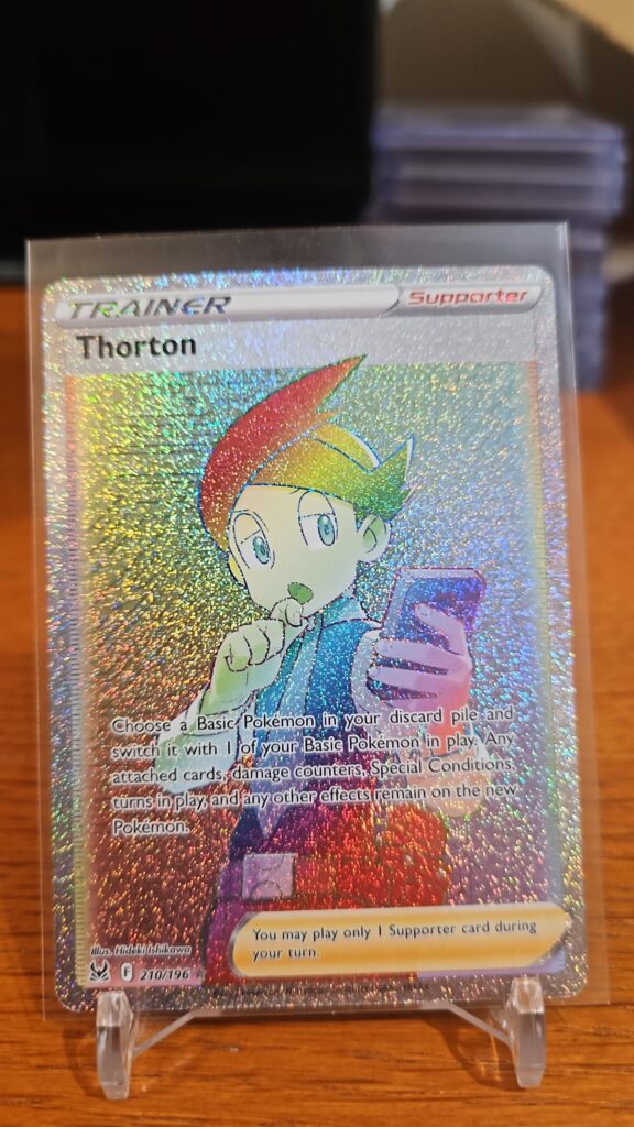 Pokémon TCG Thorton 210/196 Lost Origin Rainbow Secret Rare Full Art Trainer card displayed in near mint condition, showcasing detailed rainbow foil illustration and holographic finish for collectors.