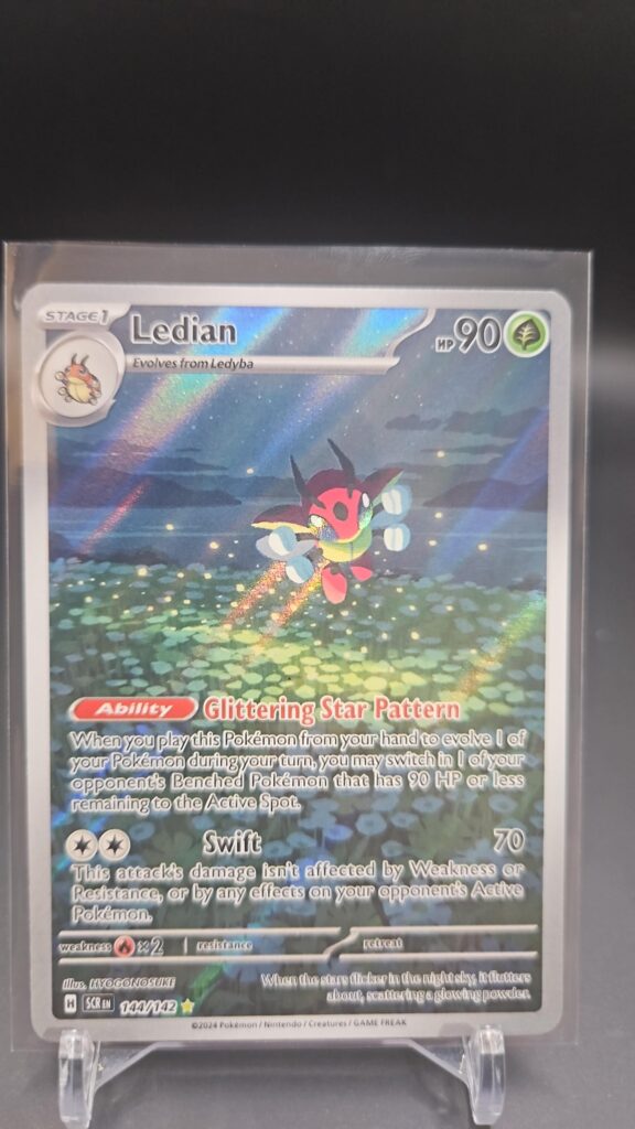 Pokémon TCG Ledian 144/142 Stellar Crown Illustration Rare Full Art Holo card displayed in near mint/mint condition, showcasing detailed full-art illustration and holographic finish for collectors