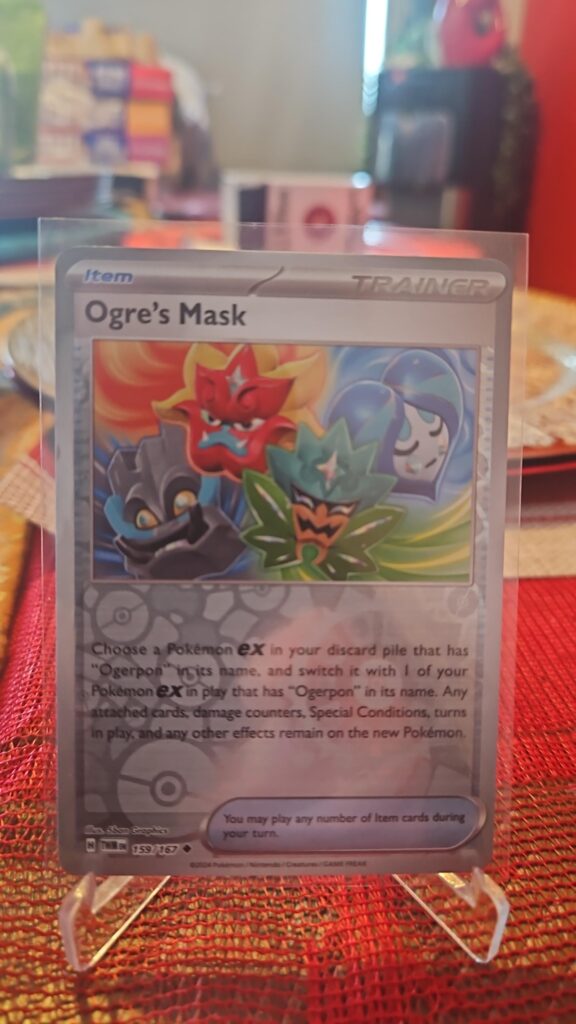 Ogre’s Mask 159/167 Reverse Holo Trainer card from Scarlet and Violet Twilight Masquerade, illustrated by Studio GALA, shown in Near Mint condition with reflective parallel‑foil background.