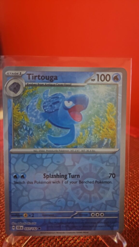 Tirtouga Reverse Holo Pokémon card from Pokémon TCG Stellar Crown, illustrated by Tika Matsuno, shown in Near Mint condition with reflective parallel‑foil background.