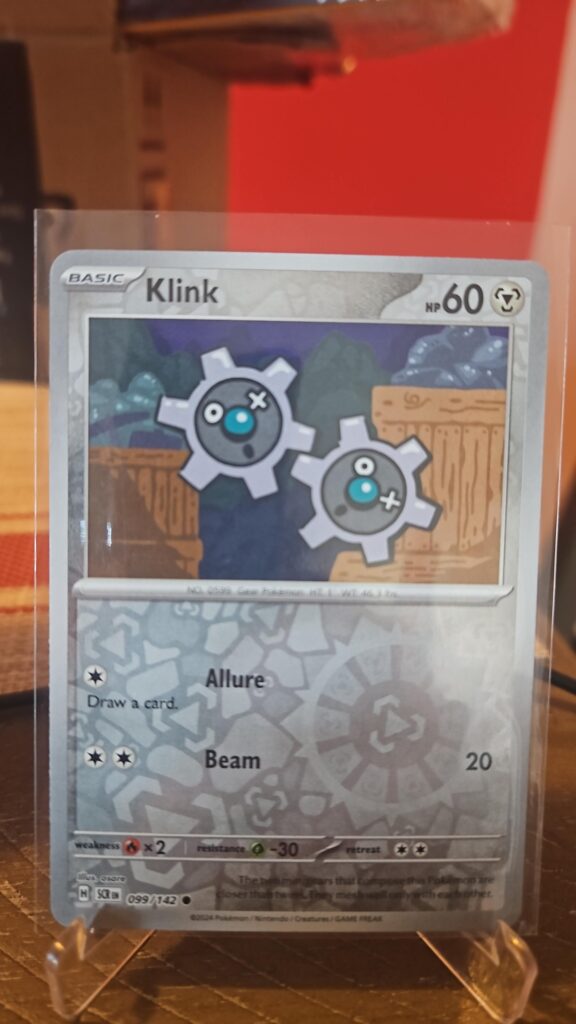 Klink 099/142 Reverse Holofoil common single card from Pokemon TCG Stellar Crown set