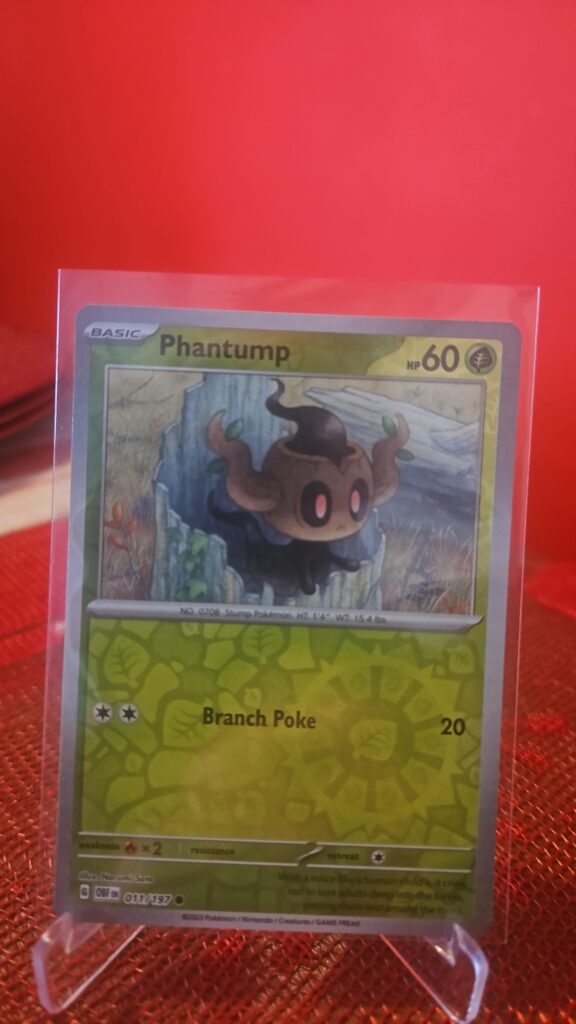 Phantump Reverse Holo Pokémon card from Pokémon TCG Obsidian Flames, illustrated by Tika Matsuno, shown in Near Mint condition with reflective parallel‑foil background.