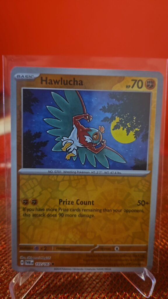 Reverse Holo Hawlucha 107/167 from Pokémon TCG Twilight Masquerade with silver border and reflective foil.