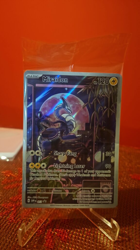 Sealed Pokémon TCG Miraidon SVP EN 013 Black Star Promo Illustration Rare card displayed in original packaging, showcasing vibrant full-art illustration and exclusive promo status for collectors.