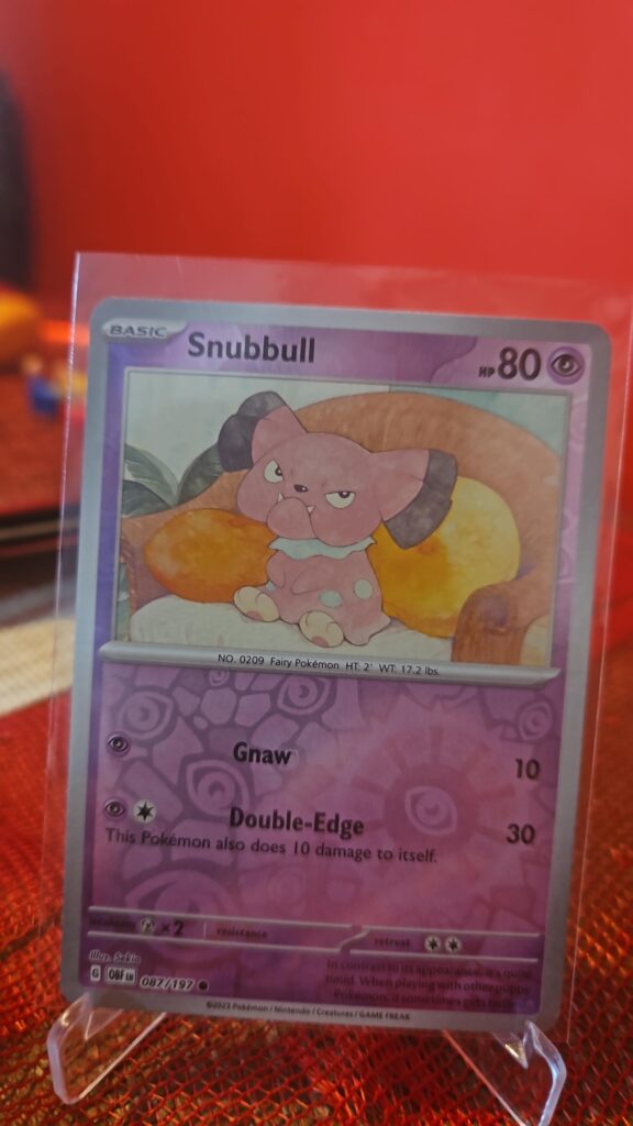 Snubbull Reverse Holo Pokémon card from Pokémon TCG Obsidian Flames, illustrated by Tika Matsuno, shown in Near Mint condition with reflective parallel‑foil background.
