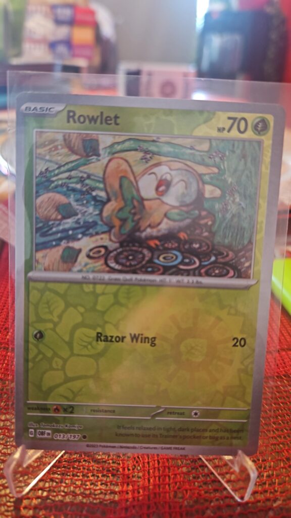 Rowlet Reverse Holo Pokémon card from Scarlet and Violet Obsidian Flames, Near Mint