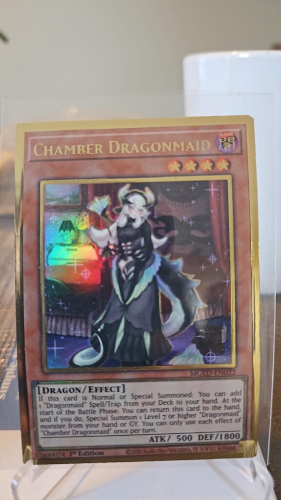 Yu-Gi-Oh! Chamber Dragonmaid MGED-EN022 Gold Rare 1st Edition card, collectible gold finish, highly sought after by Dragonmaid and TCG fans