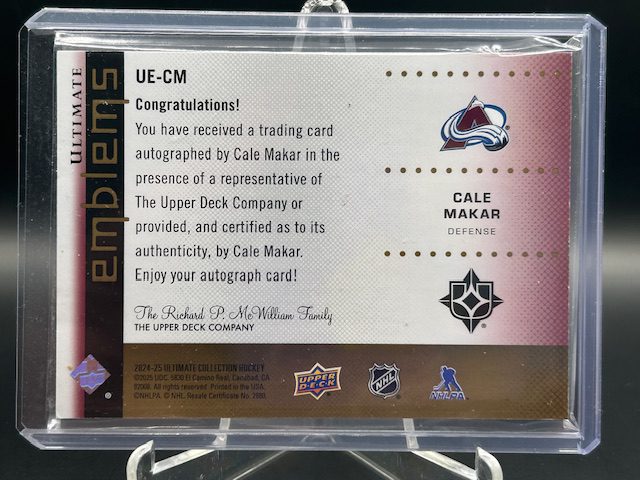 Back view of 2025-26 Upper Deck Ultimate Collection Cale Makar Ultimate Emblems Autograph Gold hockey card serial numbered /25 showing player stats and authenticity text
