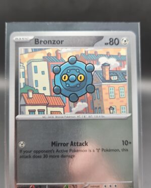 Bronzor 063/084 Reverse Holo Pokémon card from Pitch Black ME05 in Near Mint condition.