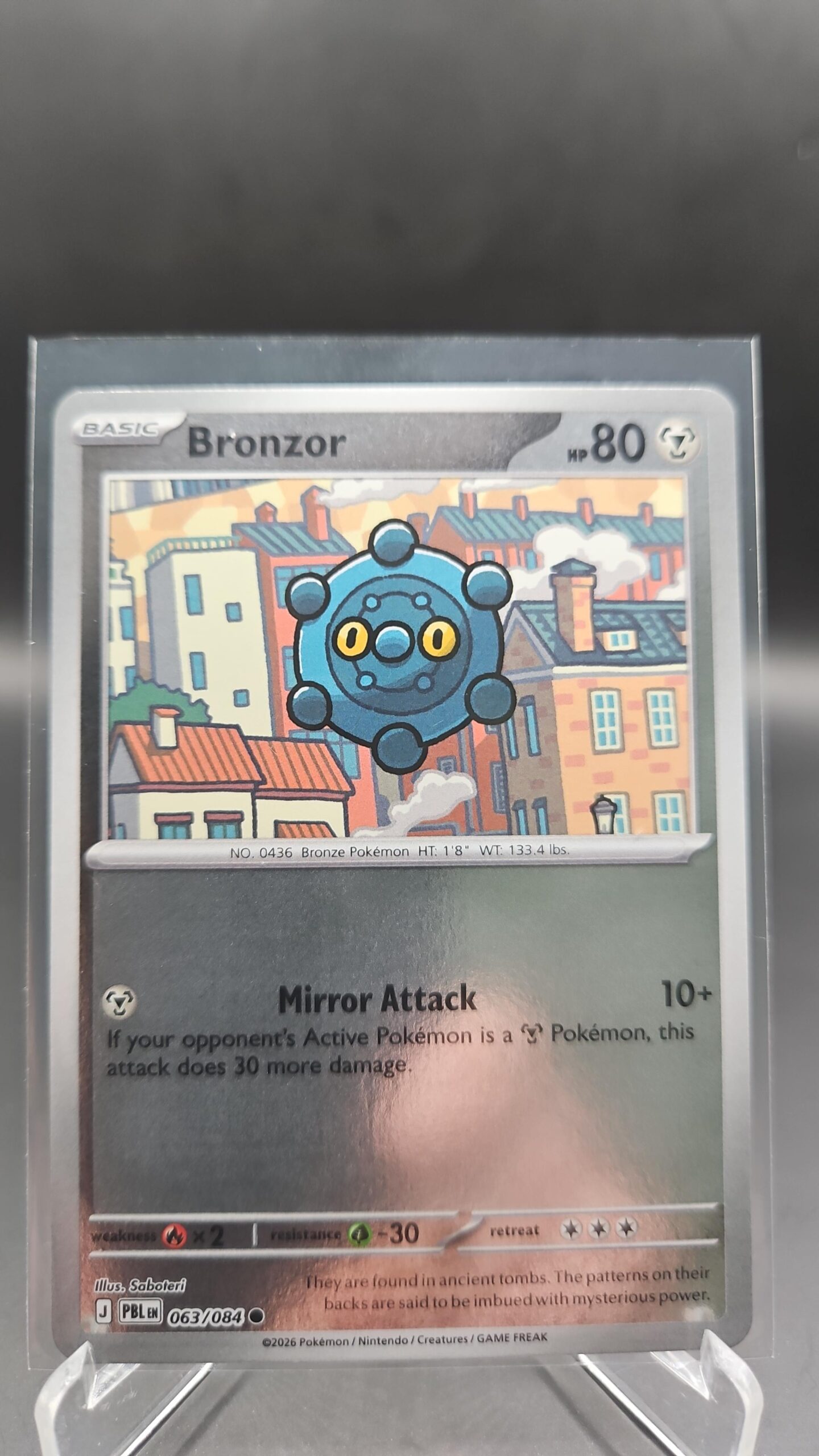 Bronzor 063/084 Reverse Holo Pokémon card from Pitch Black ME05 in Near Mint condition.