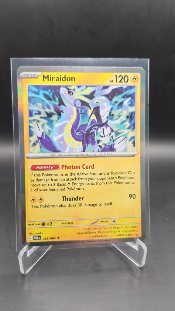 Miraidon 028/084 Rare Holo Pokémon card from Pitch Black ME05 in Near Mint condition.