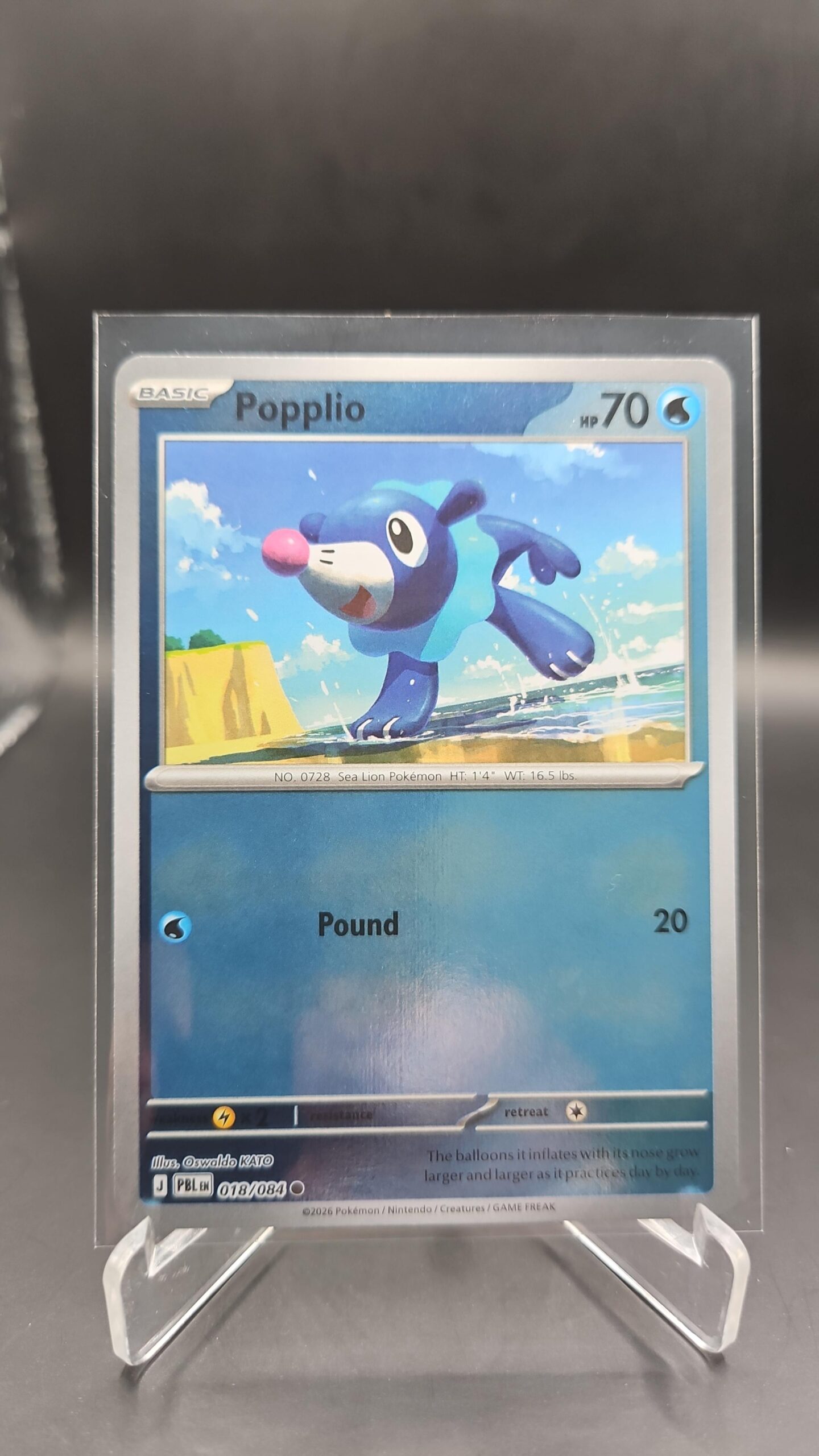 Popplio 018/084 Reverse Holo Pokémon card from Pitch Black ME05 in Near Mint condition.