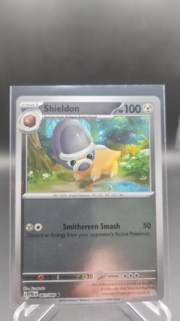 Shieldon 061/084 Reverse Holo Pokémon card from the Mega Evolution Era Pitch Black ME05 set in Near Mint condition.